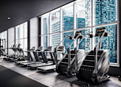 Thumbnail 22 of 34 - A gym with treadmills and a view of the city.