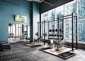 Thumbnail 20 of 34 - A gym with a view of the city outside the window.