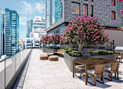 Thumbnail 12 of 34 - A patio with a table and chairs overlooks a city skyline.