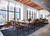 Thumbnail 31 of 34 - A modern dining room with wooden tables and chairs.