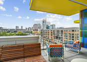 Thumbnail 4 of 25 - a rooftop terrace with chairs and a view of the city at Link Apartments® Mint Street, Charlotte, NC