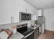 Thumbnail 12 of 22 - Modern kitchen with stainless steel appliances at Link ® Lake Park Apartments, Smyrna, 30080