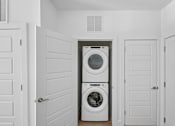 Thumbnail 14 of 22 - Stacked washer and dryer in closet at Link ® Lake Park Apartments, Smyrna