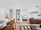 Thumbnail 2 of 39 - A modern kitchen with a dining table and chairs.at Link Apartments® QPN, Long Island City New York