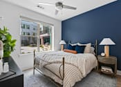 Thumbnail 13 of 22 - Modern bedroom with navy accent wall at Link ® Lake Park Apartments, Georgia