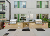 Thumbnail 18 of 22 - Outdoor grilling area with twin barbecue stations at Link ® Lake Park Apartments, Smyrna, GA 30080