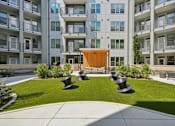 Thumbnail 9 of 22 - Courtyard with green lawn and modern sculptures at Link ® Lake Park Apartments, Smyrna, 30080