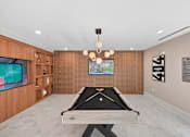 Thumbnail 16 of 22 - Game room with pool table and entertainment screens at Link ® Lake Park Apartments, Smyrna, Georgia