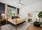Thumbnail 5 of 32 - a bedroom with a bed in a room with a large window at Link Apartments® 4th Street, Winston-Salem, 27101