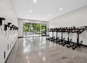 Thumbnail 20 of 22 - Fitness center bike storage with charging stations at Link ® Lake Park Apartments, Smyrna, GA