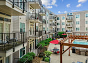 Thumbnail 21 of 28 - a view of an apartment building with a pool at Link Apartments® Brookstown, Winston Salem, NC
