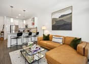 Thumbnail 7 of 32 - a living room and kitchen with a couch and a glass table at Link Apartments® 4th Street, North Carolina