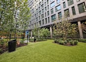 Thumbnail 29 of 39 - A grassy area in front of a building at Link Apartments® QPN, Long Island City, New York