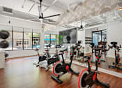 Thumbnail 11 of 32 - the gym has plenty of exercise bikes and other fitness equipment at Link Apartments® 4th Street, Winston-Salem