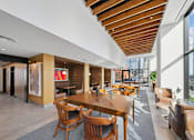 Thumbnail 34 of 39 - A modern dining area with wooden chairs and tables at Link Apartments® QPN, Long Island City, New York