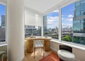 Thumbnail 3 of 39 - A room with a desk and chair in front of a window with a city view.at Link Apartments® QPN, New York