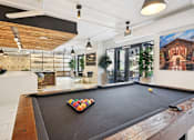 Thumbnail 15 of 32 - a large room with a pool table in the middle at Link Apartments® 4th Street, Winston-Salem, NC, 27101
