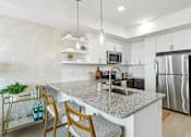 Thumbnail 1 of 32 - a kitchen with stainless steel appliances and granite counter tops  at Link Apartments® H Street, Washington, DC, 20002