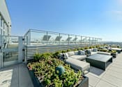 Thumbnail 18 of 32 - a terrace with couches and tables on a roof top  at Link Apartments® H Street, Washington, DC
