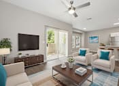 Thumbnail 7 of 23 - A living room with a white couch, a wooden coffee table, and a flat screen TV.