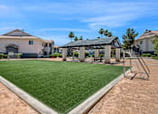 Thumbnail 18 of 27 - A house with a green lawn and a playground.