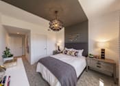Thumbnail 6 of 38 - a bedroom with a large bed and a white table