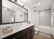Thumbnail 8 of 24 - a bathroom with a large mirror and a toilet and a shower