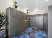 Thumbnail 18 of 21 - A hallway with a blue tiled floor and grey walls.