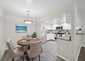Thumbnail 23 of 29 - A modern kitchen with a dining table and chairs.