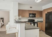Thumbnail 2 of 28 - a kitchen with an island and a stove and a refrigerator