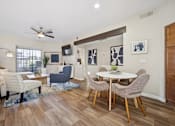 Thumbnail 3 of 21 - A living room with a white table and chairs.