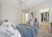 Thumbnail 6 of 20 - a bedroom with a bed and a ceiling fan