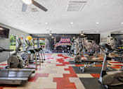 Thumbnail 24 of 30 - A gym with treadmills and exercise equipment.
