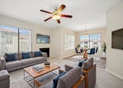 Thumbnail 11 of 33 - A living room with a grey couch and a coffee table.