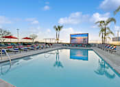 Thumbnail 16 of 31 - A large screen is mounted on a wall above a swimming pool.