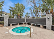 Thumbnail 9 of 17 - A small pool surrounded by a concrete patio and a metal fence.