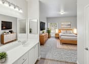 Thumbnail 7 of 20 - A bedroom with a bed, dresser, and mirror.