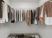 Thumbnail 7 of 15 - a rack of clothes and shoes in a closet