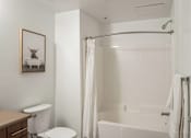 Thumbnail 10 of 28 - a bathroom with a shower and a toilet and a sink