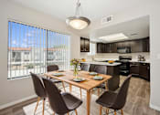 Thumbnail 3 of 33 - A modern dining room with a wooden table and chairs.