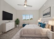 Thumbnail 8 of 23 - A bedroom with a large bed, a flat screen TV, and a ceiling fan.