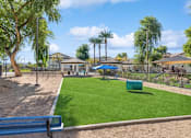 Thumbnail 20 of 24 - a park with a playground and picnic tables and trees