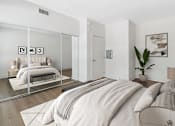 Thumbnail 4 of 15 - a bedroom with a large bed and a mirror