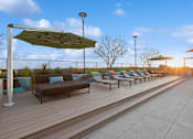 Thumbnail 20 of 31 - A row of lounge chairs and umbrellas are set up on a wooden deck.