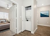 Thumbnail 12 of 23 - A modern kitchen with white appliances and a wooden floor.