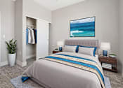 Thumbnail 5 of 27 - A bedroom with a large bed and a painting of a beach scene on the wall.