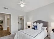 Thumbnail 5 of 20 - a bedroom with a large bed and a ceiling fan
