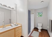 Thumbnail 4 of 16 - a bathroom with a sink and a toilet and a shower