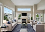 Thumbnail 6 of 27 - A living room with a fireplace and a television.