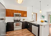 Thumbnail 1 of 31 - A modern kitchen with a wooden backsplash and stainless steel appliances.